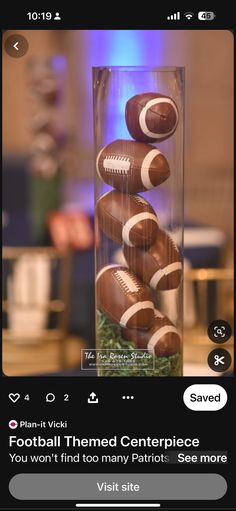 a vase filled with footballs sitting on top of a table