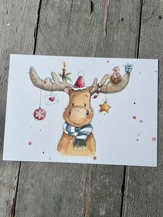 a card with an image of a moose wearing a christmas hat and scarf on it's head