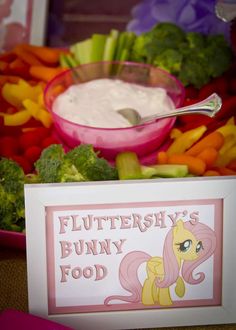 a bowl of fruit and vegetables with a sign that says flutter's bunny food