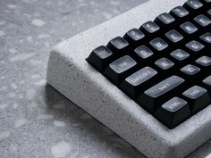 a black and white keyboard sitting on top of a table