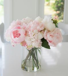 a vase filled with pink and white flowers