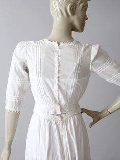 An Edwardian era blouse. The small white cotton blouse features intricate white embroidery. Sweet little buttons closes the blouse down the back. There is lace trim at neck, pin tuck detailing, and three-quarter sleeves. CONDITION In good antique condition. There is a worn spot on back of waistband. Holes do not go all the way through. There is some thinning and wear to the left shoulder. SIZE & MEASUREMENTS Approximate SizeXS Bust32 inch ...81.3 cm Length13.5 inch ... 34.3 cm Shoulders15.5 Luxury Pintucks Blouse For Women, Luxury Cotton Unstitched Blouse, Luxury Cotton Blouse For Eid, Luxury Vintage Cotton Blouse, Edwardian Blouse Pattern, Edwardian Blouse, White Cotton Top, Pucci Dress, White Cotton Blouse