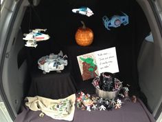 the trunk of a car is filled with toys and cards, including star wars figurines