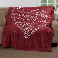 a living room with a couch covered in a red blanket that has names on it