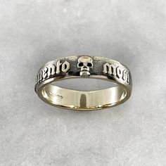 The Memento Mori Ring is not just a piece of jewelry; it is a talisman of empowerment and introspection. By wearing this ring, you carry a symbol of your own mortality, inviting reflection and inspiring a deeper appreciation for the fleeting beauty of life. It serves as a reminder to live fully, embracing the joys and challenges that come your way. Ring is 6mm wide. Solid 9k Yellow Gold with an aged Black Ruthenium finish. Each piece is handmade to order in our Jewel Thief Brighton Atelier. Memento Mori Ring, Skull Wedding Ring, Phrase Meaning, Jewelry Skull, Skull Wedding, Gold Skull, Like A Rock, Etsy Wedding Rings, Beauty Of Life