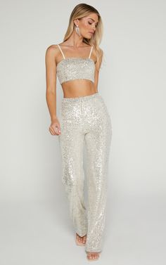 Dazzle on your next party night with our Imogen Bandeau Top Two Piece Set in Silver Sequin. This co-ord pants set is perfect for making a statement, featuring a strapless bandeau top and skinny leg pants fully adorned with shimmering silver sequins. The full-length design ensures you'll turn heads as you stride through the room, while the coordinated pieces make it effortless to achieve that glam look without any fuss. So whether you're heading to a swanky rooftop soiree or hitting the club with All White Disco Outfit, Fitted Bottoms For Summer Prom, Strapless Stretch Party Sets, Fitted Party Sets, Fitted Sets For Party Season, Fitted Party Sets For Party Season, Sequined Bottoms For Prom And Party Season, Stretch Sequin Party Sets, Glamorous Fitted Bottoms With Shine