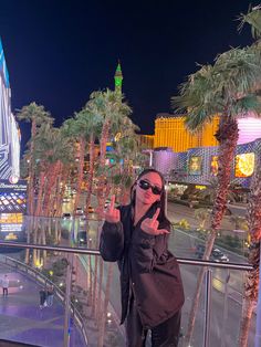 a woman taking a selfie in front of the las vegas strip