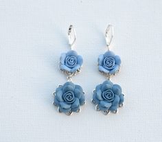 Featuring Dusty Blue and Claudy Blue Double Roses Earrings. Different color shades are welcome. Variety blue roses available in my shop. Hand-sculpted Rose. Size approx : 13-14mm ( smaller Rose ) and 18-19mm ( larger Rose) Entire length aprox : 50mm. Antiqued silver plated brass filigree. Lever Back ; silver Plated ( pictured). available in Gold Plated and antiqued brass. Handmade in 3-5 business days prior shipping for a single item. However if you need them sooner, please drop a note. Custom o Roses Earrings, Blue Earrings Wedding, Teen Jewelry, Earrings Aesthetic, Steampunk Accessories, Prom Jewelry, Small Rose, Blue Roses, Floral Jewellery