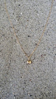 "Beautiful. Delicate Tiny gold 6mm (0.23 inches) puffed heart hangs delicately from a gold fill chain. The heart is puffed on both sides and hollow in the center. Made from high quality tarnish resistant gold fill. Shown here in 16\" length. *If you are unsure of the length you need, or would like to wear this item at different lengths, we now offer an adjustable length option! You can add an adjustable end to your necklace using this link: https://www.etsy.com/listing/791277751/necklace-extensi Gold Charm Necklace With Heart Charm And Round Pendant, Gold Charm Necklace With Heart Pendant, Gold Heart Pendant Necklace With Heart Print, Gold Heart Necklace With Heart Pendant, 14k Gold Filled Heart Pendant Necklace For Anniversary, Gold Plated Heart Necklace With Heart Charm, Gold Heart Necklace With Heart Print For Valentine's Day, 14k Gold Filled Heart Necklace For Anniversary, 14k Gold-filled Heart Pendant Necklace For Anniversary