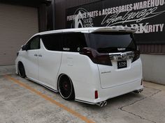 a white van parked in front of a building