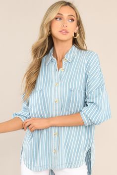 Looking for an effortless classic? This Always Lovely Blue Striped Top is your go-to for effortless, casual style. Throw it on and get ready for the compliments! This top features a collared neckline, functional buttons down the front, two functional bust pockets, long sleeves with buttoned cuffs, a scoop bottom hem, and a super soft material. 100% Lyocell Hand Wash Cold Unlined Imported Model is wearing a small Blue Tops With Roll-up Sleeves For Daywear, Blue Tops With Roll-up Sleeves For Spring, Blue Collared Top With Pockets, Blue Top With Pockets And Collared Neckline, Blue Tops With Roll-up Sleeves For Everyday, Blue Collared Top With Roll-up Sleeves, Blue Workwear Top With Buttoned Pockets, Blue Workwear Tops With Buttoned Pockets, Trendy Blue Top With Collared Neckline