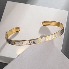 Declare your faith stylishly with our "Jesus & Cross" Gold Stainless Steel Cuff Bracelet. The elegant design features the sacred name 'Jesus' alternating with cross symbols, delivering a strong statement of belief while complementing your everyday outfits. #eBay #eBaySeller #StainlessSteel #Cuff #Bracelet #Jewelry #Religious Jesus Jewelry, Jesus Bracelet, Prayer Jewelry, Fish Hook Bracelet, Cross Gold, Open Bracelet, Fish Hook Necklace, Compass Bracelet, Whale Necklace