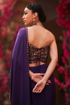 Purple pre-draped saree with cowl drapes. Paired with a padded corset blouse with all over embroidery using gold cutdana, beads and salli work. - Aza Fashions Draped Choli With Mirror Work For Reception, Reception Pre-draped Saree With Padded Blouse, Draped Blouse With Mirror Work For Reception, Bollywood Style Pre-draped Saree With Padded Blouse For Reception, Sleeveless Blouse With Dupatta For Reception, Bollywood Style Purple Pre-draped Saree, Festive Purple Pre-draped Saree With Cutdana, Purple Bollywood Style Pre-draped Saree With Cutdana, Bollywood Style Pre-draped Purple Saree