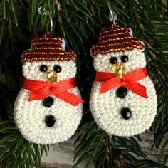 crocheted snowman ornament hanging from a christmas tree