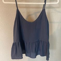 Greyish Blue Crop Top With Ruffle Detail. Adjustable Straps, Size 4 Blue Ruffled Cami Tank Top, Spring Blue Camisole With Ruffles, Blue Ruffled Camisole For Spring, Blue Cami Camisole For Day Out, Blue Camisole For Day Out, Vacation Blue Ruffled Tank Top, Blue Camisole Tops For Vacation, Blue Ruffled Top With Spaghetti Straps, Blue Spaghetti Strap Top With Ruffles