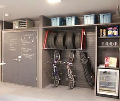 a bicycle is parked in front of a chalkboard and shelves with items on it