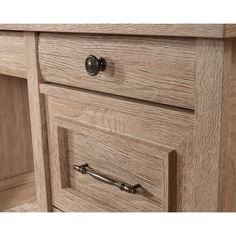 a close up view of the drawers and handles on a wooden cabinet with metal pulls