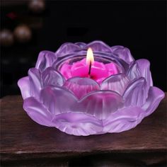 a candle that is sitting in a glass bowl