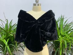 a woman's black fur stole on top of a mannequin