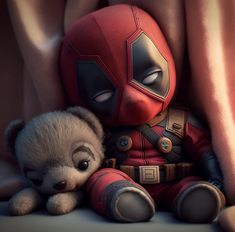 a small teddy bear sitting next to a deadpool character with his eyes wide open