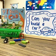 there is a green basket and some toys on the floor next to books about cars