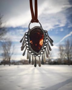 This necklace features an earthy red moss agate set in sterling silver bearing solder with a hammered metal fringe. The solder is jewelry grade and is finished with an antique patina and a protective wax polish. The cord is soft deerskin leather and is fully adjustable via two sliding knots, so this statement piece can be worn long or short. Earthy Hand Forged Pendant Jewelry, Bohemian Amber Jewelry Hand Forged, Bohemian Amber Jewelry With Hand Forged Details, Hand Forged Amber Bohemian Jewelry, Unique Hand Forged Rust Jewelry, Adjustable Earthy Soldered Jewelry, Unique Hand Forged Rust-colored Jewelry, Soft Solder Jewelry, Edgy Red Metal Necklace