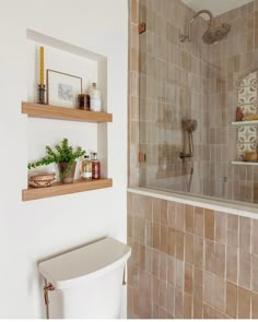 a bathroom with two shelves on the wall