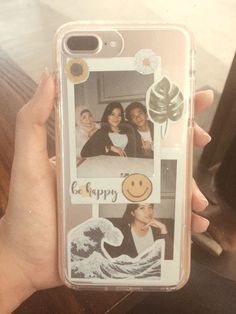 a person holding up a cell phone case with two pictures on it and the words go happy