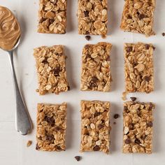 granola bars with chocolate chips and oatmeal are arranged next to a spoon