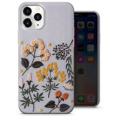 an iphone case with flowers and leaves on the front, sitting next to an iphone