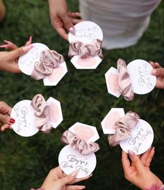 several people are holding up small cards with bows on them, and the words happy birthday written on them