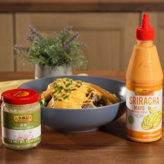 an image of food on the table with mustard and seasoning bottles next to it