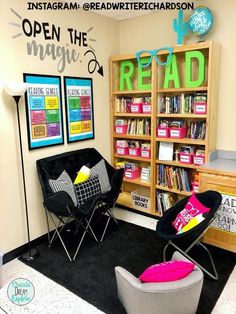 a library with chairs, bookshelves and posters on the wall