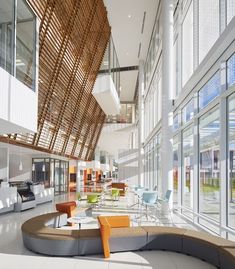 the interior of an office building with lots of windows and seating area in front of them