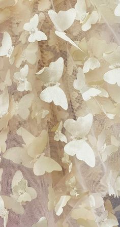 white flowers are on the sheer fabric