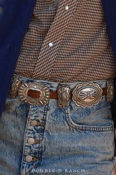 A CLASSIC CONCHO BELT IS A SOUTHWESTERN STAPLE. How stunning is this contemporary concho belt? The slender leather strap is adorned with 7 classic sterling silver scallop conchos alternated by 8 butterfly concho spacers, and finished with a complementing concho frame buckle. Timeless and classic – a must-have for every cowgirl’s closet. materials: sterling silver, leather strap dimensions on buckle 2 1/2" 7 conchos at 2 1/2" x 2 1/4" 8 butterfly spacers 2" x 1" belt fits 32" weight: 416 grams ni Concho Leather Belt, Classic Concho Belt Buckles For Rodeo, Formal Adjustable Concho Belt, Classic Antique Belt Buckles For Ranch, Classic Concho Belt For Western-themed Events, Classic Adjustable Embroidered Belt, Classic Concho Belt Buckles, Elegant Brown Belt With Concho, Elegant Concho Belt For Formal Wear