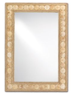 a mirror that is made out of wood and has shells on the border around it