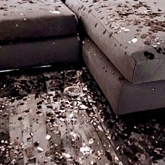 the floor is littered with confetti on it and there are two couches