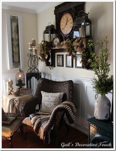 a living room filled with furniture and pictures on the wall