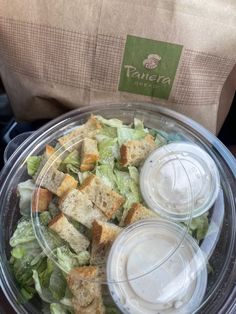 a plastic bowl filled with salad and dressing