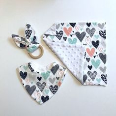 a baby bib and bandana set on a white surface with scissors next to it