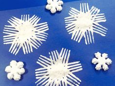 snowflakes are arranged on a blue surface