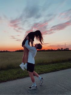 a man is lifting up a woman in the air