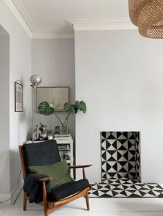 a living room with white walls and black and white geometric rugs on the floor