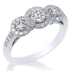 three stone diamond ring in white gold with diamonds around the band and sidestones on each side