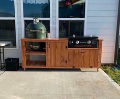 an outdoor bbq grill on the side of a house