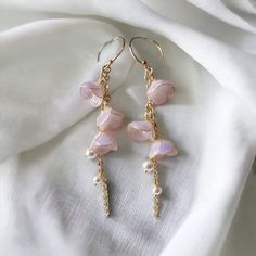 🌸 Introducing our Japanese vintage style earrings that are in the shape of lily of the valley. 🌸 The dangles showcase intricately designed Chinese elements, adding a cute and elegant touch to your look. 🌸 What's unique about Lily of The Valley: A symbol of purity, joy, love, sincerity, happiness and luck, lily of the valley has much significance beyond the United Kingdom. It's actually the national flower of Finland, and in France, on 1st May for La Fête du Muguet, lily of the valleys are gifted to loved ones. 🌸 Crafted with hypoallergenic materials, these earrings offer a comfortable and safe wearing experience.  🌸 The lightweight design makes them perfect for everyday wear or as an exquisite accessory for formal events. 🌸 Ideal for various occasions, including weddings, parties, or Feminine Flower Dangle Earrings With Pearl Drop, Feminine Dangle Bridal Earrings, Dangle Flower Earrings With Ear Wire For Mother's Day, Dangle Pearl Drop Flower Earrings For Anniversary, Pearl Drop Dangle Flower Earrings For Anniversary, Feminine Dangle Earrings For Anniversary, Anniversary Flower Dangle Earrings With Pearl Drop, Mother's Day Anniversary Dangle Flower Earrings, Mother's Day Anniversary Flower Dangle Earrings