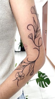 a woman with a flower tattoo on her arm