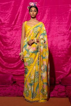 Yellow chanderi silk saree with floral print and pearl embellished scallop hem border. Comes with unstitched blouse piece.
Components: 2
Pattern: Printed
Type Of Work: Floral
Fabric: Chanderi Silk, Lining: Shantoon
Color: Yellow
Other Details: 
Pearl embellished scallop border
Length:
Saree: 5.5 mtrs
Blouse: 1 mtrs
Note: Stitched blouse worn by the model is not for sale
Occasion: Sangeet - Aza Fashions Saree Gowns, Cotton Sarees Handloom, Scallop Border, Floral Saree, Ruffle Saree, Chanderi Silk Saree, Scallop Hem, Lehenga Saree, South Indian Bride