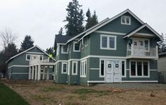 the house is painted green and has white trim